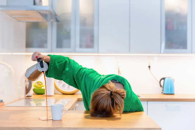 Woman is so tired that she sleeps while pouring her coffee